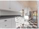 White kitchen with granite countertops, stainless steel appliances, and checkered floor at 4770 Winterberry Pl, Columbus, IN 47201