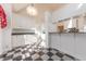 White kitchen with granite countertops, island, and checkered floor at 4770 Winterberry Pl, Columbus, IN 47201