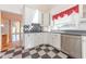 White kitchen with granite countertops, stainless steel appliances, and checkered floor at 4770 Winterberry Pl, Columbus, IN 47201