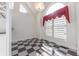 Bright kitchen area with an arched window and checkered floor at 4770 Winterberry Pl, Columbus, IN 47201