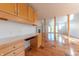 Open kitchen with wood cabinetry and views to dining area at 4770 Winterberry Pl, Columbus, IN 47201