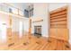 Spacious living room featuring hardwood floors, a fireplace, and built-in shelving at 4770 Winterberry Pl, Columbus, IN 47201