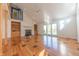 Bright living room with hardwood floors, a fireplace, and access to a backyard patio at 4770 Winterberry Pl, Columbus, IN 47201