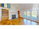 Spacious living room with hardwood floors, fireplace, and built-in shelving at 4770 Winterberry Pl, Columbus, IN 47201