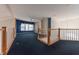 Open loft area with blue walls, built-in shelves and carpet at 4770 Winterberry Pl, Columbus, IN 47201