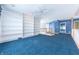 Loft with blue walls, built-in shelving, and carpet flooring at 4770 Winterberry Pl, Columbus, IN 47201