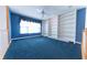 Spacious loft area with blue walls, built in shelving and blue carpet at 4770 Winterberry Pl, Columbus, IN 47201