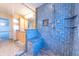 Large walk-in shower with blue tile, built-in seat, and multiple shower heads at 4770 Winterberry Pl, Columbus, IN 47201
