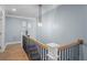 Upper hallway with wood floors, light walls, and a chandelier at 5765 W 100 N, Greenfield, IN 46140