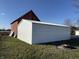 Rear view of a white metal garage, providing additional storage or workshop area at 6095 W 1900 N, Elwood, IN 46036