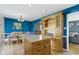 Kitchen with light wood cabinets, center island, and blue walls at 6104 W Elaine St, Indianapolis, IN 46224