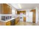 Kitchen with white appliances and wood cabinets at 6403 Cradle River Dr, Indianapolis, IN 46221