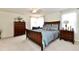 Bright main bedroom with a large bed and ample dresser space at 6625 Harvest Moon Ln, Whitestown, IN 46075