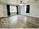 Spacious living room with hardwood floors and ceiling fan at 716 Smith St, Columbus, IN 47201