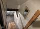 View of unfinished basement with wooden stairs and exposed beams at 915 N Parker Ave, Indianapolis, IN 46201