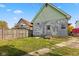 Rear view of a house needing paint with a small yard at 14 N Tacoma Ave, Indianapolis, IN 46201