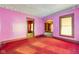 Living area featuring pink walls and red carpeting at 14 N Tacoma Ave, Indianapolis, IN 46201