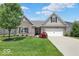 Brick ranch home with 2-car garage, landscaping, and a large front yard at 14144 Stoney Shore Ave, McCordsville, IN 46055