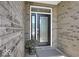 Modern black front door with glass inserts and brick exterior at 14144 Stoney Shore Ave, McCordsville, IN 46055