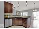 Kitchen features dark wood cabinets, granite counters, and stainless steel appliances at 14144 Stoney Shore Ave, McCordsville, IN 46055