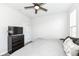 Bedroom with king bed, dresser, and TV; featuring a ceiling fan and large window at 18943 Karyn Ln, Noblesville, IN 46062