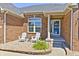 Inviting front porch with white chairs and landscaping at 1945 Saratoga Dr, Greenwood, IN 46143