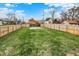 Large grassy backyard enclosed by a wooden fence at 2202 Bellefontaine St, Indianapolis, IN 46205