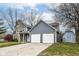 Gray house with stone chimney, two-car garage, and shed at 3502 Oak Tree Cir, Indianapolis, IN 46227