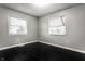 Spacious bedroom with dark hardwood floors and two windows at 3920 N Layman Ave, Indianapolis, IN 46226