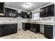 Kitchen with dark wood cabinets and granite countertops at 3920 N Layman Ave, Indianapolis, IN 46226