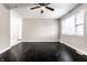 Living room featuring dark hardwood floors and a ceiling fan at 3920 N Layman Ave, Indianapolis, IN 46226