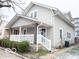 Two-story house with light beige siding, front porch, and landscaping at 50 W Pennsylvania St, Shelbyville, IN 46176