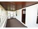 Enclosed front porch with wood ceiling and carpet flooring at 5064 Ford St, Indianapolis, IN 46224