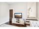 Living room with a TV stand, staircase, and hardwood floors at 507 E 5Th St, Sheridan, IN 46069