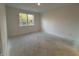 Simple bedroom with neutral walls, a window, and light-colored flooring at 5127 Cartland Dr, Indianapolis, IN 46239