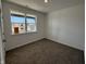 Bright bedroom featuring grey carpet and a window at 5127 Cartland Dr, Indianapolis, IN 46239