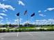 Community entrance with flags and a landscaped roundabout at 6196 Granby Dr, Whitestown, IN 46075