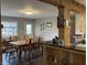 Dining room with wooden table and chairs, offering a view into the kitchen at 890 N State Road 75, Lebanon, IN 46052