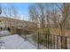 Private deck overlooking a wooded area with a light dusting of snow at 9044 Ramapo Dr, Fishers, IN 46038