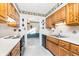 Kitchen features wood cabinets, and a view into the dining area at 9617 Lincoln Blvd, Carmel, IN 46280