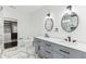 Elegant bathroom with double vanity, walk-in closet and marble flooring at 1037 Jefferson Ave, Indianapolis, IN 46201