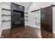 Main bedroom with dark hardwood floors, a barn door, and modern bathroom at 1037 Jefferson Ave, Indianapolis, IN 46201