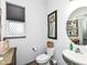 Stylish powder room with a pedestal sink and framed art at 10965 Towpath Ct, Fortville, IN 46040