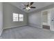 Bedroom with grey carpet, ceiling fan, and bathroom access at 1168 Oak Leaf Rd, Franklin, IN 46131