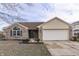 Brick ranch home with a large white garage door and landscaping at 1168 Oak Leaf Rd, Franklin, IN 46131