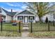 Gray house with a white porch and black fence in the front yard at 1417 Spann Ave, Indianapolis, IN 46203