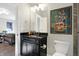 Basement bathroom with dark vanity, granite countertop, and framed art at 16334 River Crest Ct, Westfield, IN 46062