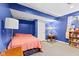 Blue basement bedroom with a bed, nightstands, and a small window at 17849 Grassy Knoll Dr, Westfield, IN 46074