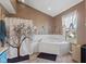 Bathroom with corner jetted tub, tile floor, and tree-themed shower curtain at 17849 Grassy Knoll Dr, Westfield, IN 46074