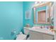 Bright and cheerful half-bath with teal walls and white vanity at 17849 Grassy Knoll Dr, Westfield, IN 46074